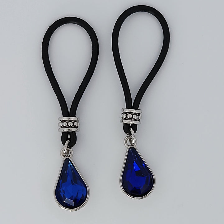 Two Dark Blue Tear Drop Gem Stone Nipple Nooses Against a White Background