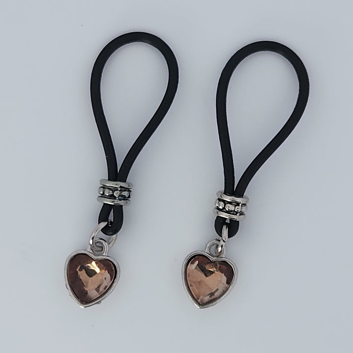 Two Tan Heart Shaped Gem Stone Nipple Nooses Against a White Background